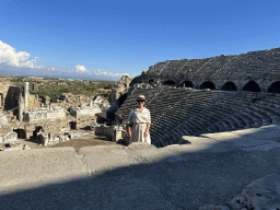 Miaomiao at the diazoma of the southwest auditorium of the Roman Theatre of Side, with a view on the auditorium, orchestra, stage and stage building