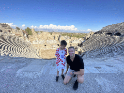 Tim and Max at the diazoma of the southwest auditorium of the Roman Theatre of Side, with a view on the auditorium, orchestra, stage and stage building