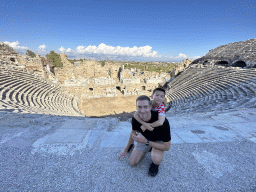 Tim and Max at the diazoma of the southwest auditorium of the Roman Theatre of Side, with a view on the auditorium, orchestra, stage and stage building