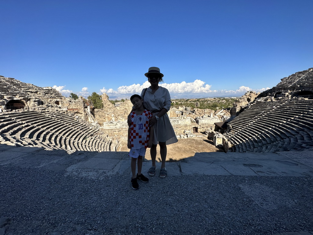 Miaomiao and Max at the diazoma of the southwest auditorium of the Roman Theatre of Side, with a view on the auditorium, orchestra, stage and stage building