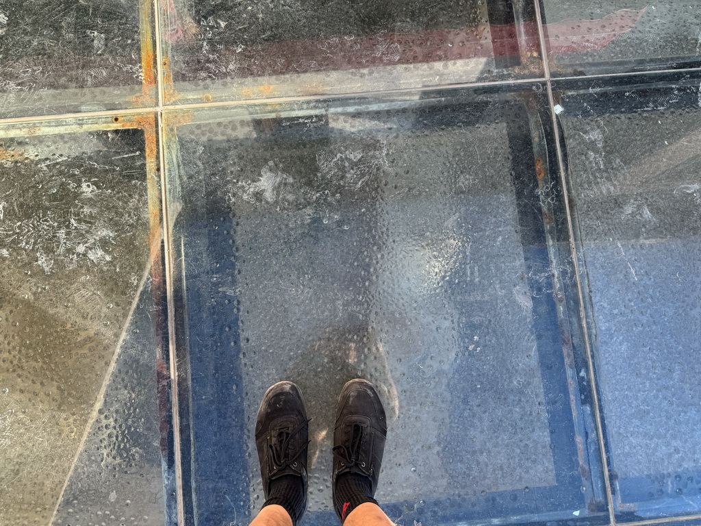 Tim standing on a glass floor with ruins underneath at the Liman Caddesi street
