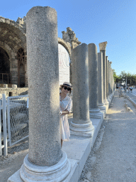 Miaomiao in front of the Temple of Dionysos and the northwest side of the Roman Theatre of Side at the Liman Caddesi street