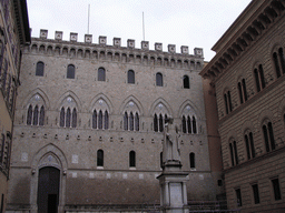 Facade of the Salimbeni Palace and a statue of Sallustio Bandini at the Piazza Salimbeni square
