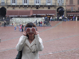 Miaomiao in front of the Gaia Fountain and the Loggia della Mercanzia building at the Piazza del Campo square