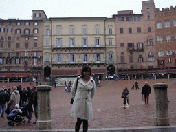 Miaomiao in front of the Gaia Fountain and the Loggia della Mercanzia building at the Piazza del Campo square