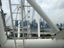 Capsules at the lower half of the Singapore Flyer ferris wheel, with a view on the ArtScience Museum and skyscrapers at the Central Business District