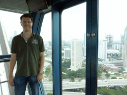 Tim in the Singapore Flyer ferris wheel, with a view on the skyscrapers at Marina Centre