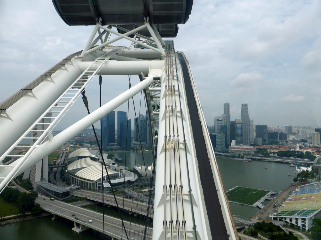 Capsules at the upper half of the Singapore Flyer ferris wheel, with a view on the Marina Bay, the Marina Bay Sands building, the ArtScience Museum, the Float at Marina Bay stadium and skyscrapers at the Central Business District