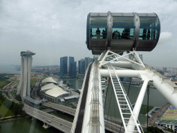 Capsules at the upper half of the Singapore Flyer ferris wheel, with a view on the Marina Bay, the Marina Bay Sands building, the Marina Bay Financial Centre, the Float at Marina Bay stadium, the Singapore Cargo Terminal and Sentosa Island, viewed from the Singapore Flyer ferris wheel