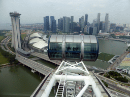 Capsules at the upper half of the Singapore Flyer ferris wheel, with a view on the Marina Bay, the Marina Bay Sands building, the Float at Marina Bay stadium and skyscrapers at the Central Business District, viewed from the Singapore Flyer ferris wheel