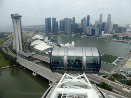 Capsules at the upper half of the Singapore Flyer ferris wheel, with a view on the Marina Bay, the Marina Bay Sands building, the ArtScience Museum, the Float at Marina Bay stadium and skyscrapers at the Central Business District, viewed from the Singapore Flyer ferris wheel