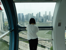 Miaomiao in the Singapore Flyer ferris wheel, with a view on Marina Bay, the Marina Bay Sands building, the Float at Marina Bay stadium and skyscrapers at the Central Business District