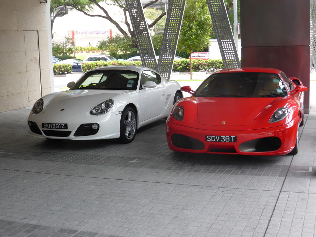 A Porsche and a Ferrari parked in front of a building at New Bridge Road