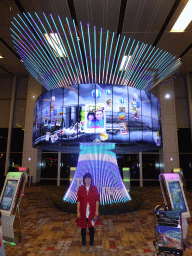 Miaomiao in front of our photograph at the Social Tree at Terminal 1 of Singapore Changi Airport