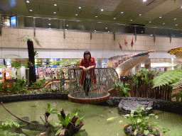 Miaomiao standing on a transparent platform at the Enchanted Garden at Terminal 2 of Singapore Changi Airport