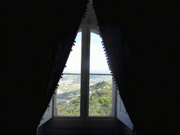 Window at the Queen`s Bedroom at the upper floor of the Palácio da Pena palace, with a view on the Castelo dos Mouros castle
