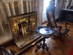 Chair, table and fireplace in a room at the upper floor of the Palácio da Pena palace