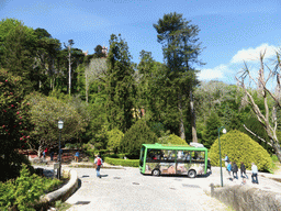 Bus at the path through the Jardins do Parque da Pena gardens, with a view on the towers of the Palácio da Pena palace