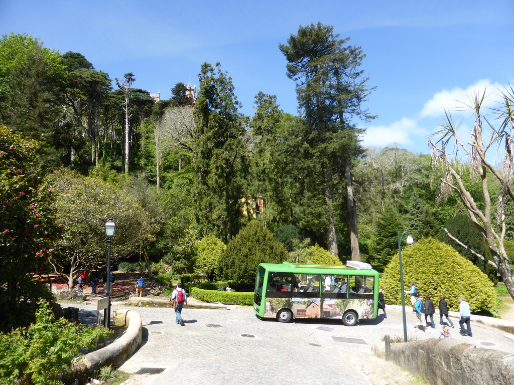 Bus at the path through the Jardins do Parque da Pena gardens, with a view on the towers of the Palácio da Pena palace