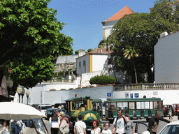 Tourist train at Praça da República square and the west side of the Palácio Nacional de Sintra palace and its gardens