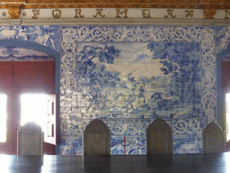 Table, chairs and painted wall tiles at the Blazons Hall at the Palácio Nacional de Sintra palace