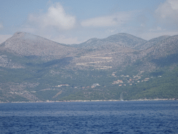 Boat on the Adriatic Sea and hills at the town of Brsecine, viewed from the Elaphiti Islands tour boat