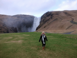 Miaomiao at the east side of the Skógafoss waterfall, with trail and platform
