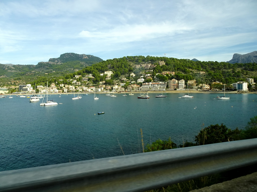 Boats in the harbour and the Platja d`en Repic beac, viewed from the rental car on the Camí del Far street