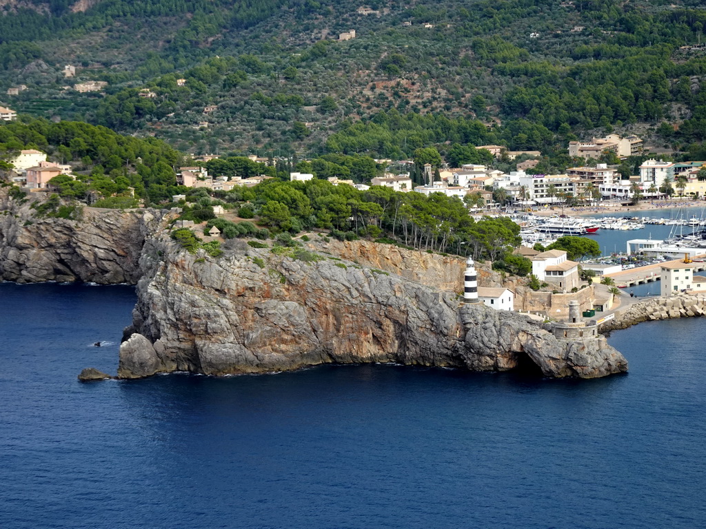 Boats in the harbour and the Faro de Punta de Sa Creu lighthouse, viewed from the northern end of the Calle Poligono street