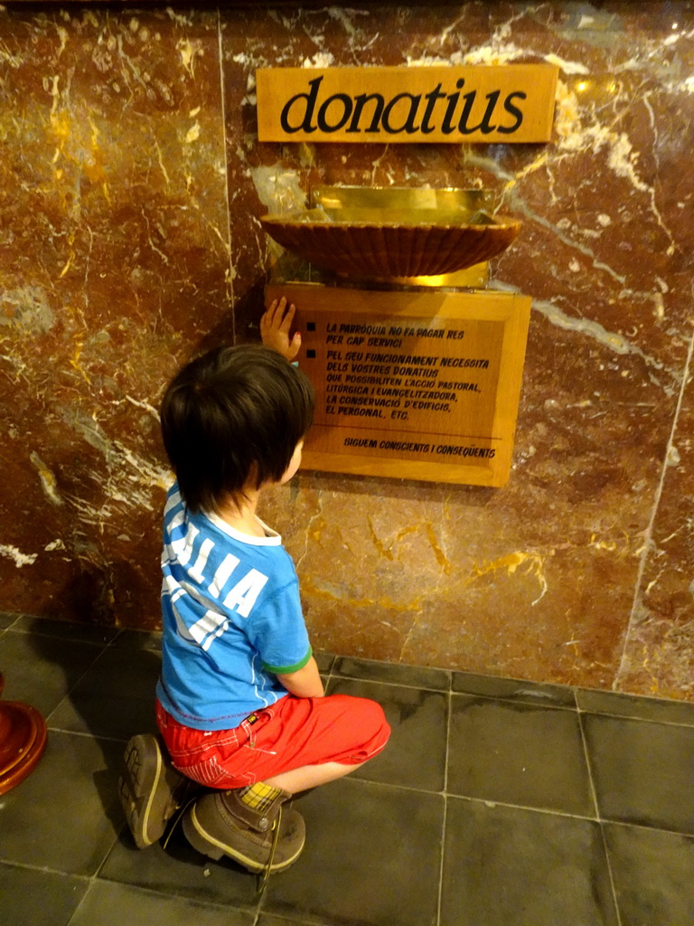 Max at a donations box at the Església de Sant Bartomeu church