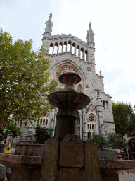 Fountain at the Plaça Constitucio square, with a view on the Església de Sant Bartomeu church