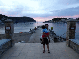 Miaomiao and Max at a pier at the east side of the harbour, with a view on the Far des Cap Gros lighthouse and the Faro de Punta de Sa Creu lighthouse, at sunset