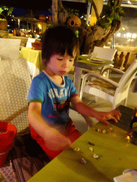 Max playing with seashells at the Restaurant Ses Oliveres