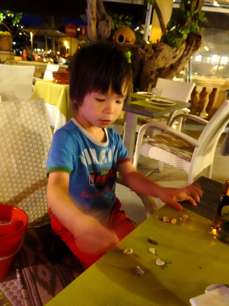 Max playing with seashells at the Restaurant Ses Oliveres