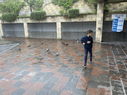 Max with pigeons in front of the entrance to the Parcheggio Comunale Achille Lauro parking lot at the Via Correale street