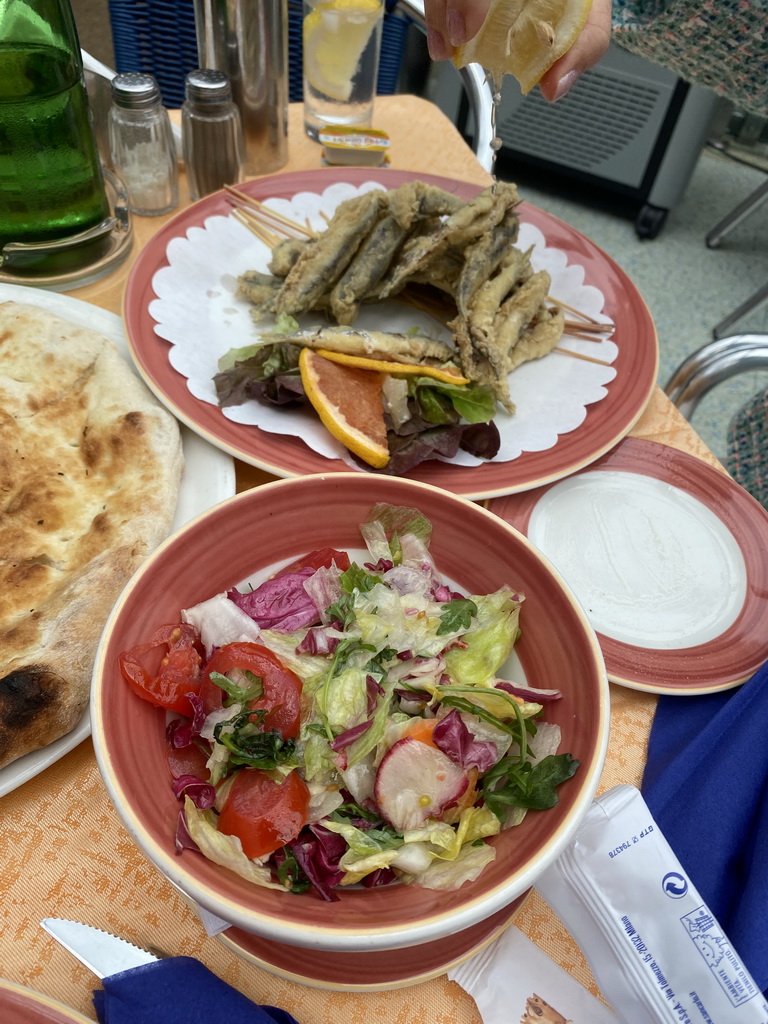 Fish and salad at the terrace of the Fauno Bar at the Piazza Torquato Tasso square