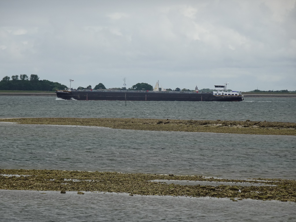 Boat on the National Park Oosterschelde, viewed from the beach near the Dijkweg road