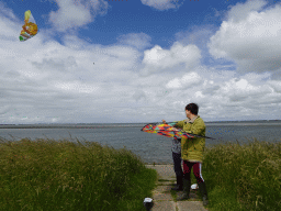 Miaomiao and our friend flying a kite at the dyke near the Dijkweg road