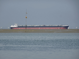 Boat at the National Park Oosterschelde and the Zeelandbrug bridge, viewed from the beach near the Dijkweg road