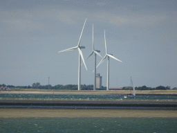 Windmills and boat at the National Park Oosterschelde, viewed from the beach near the Dijkweg road