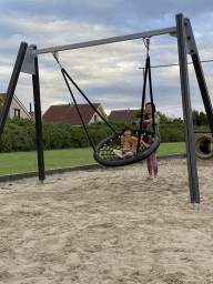 Miaomiao and Max on a swing at the playground at the Oosterschelde Camping Stavenisse