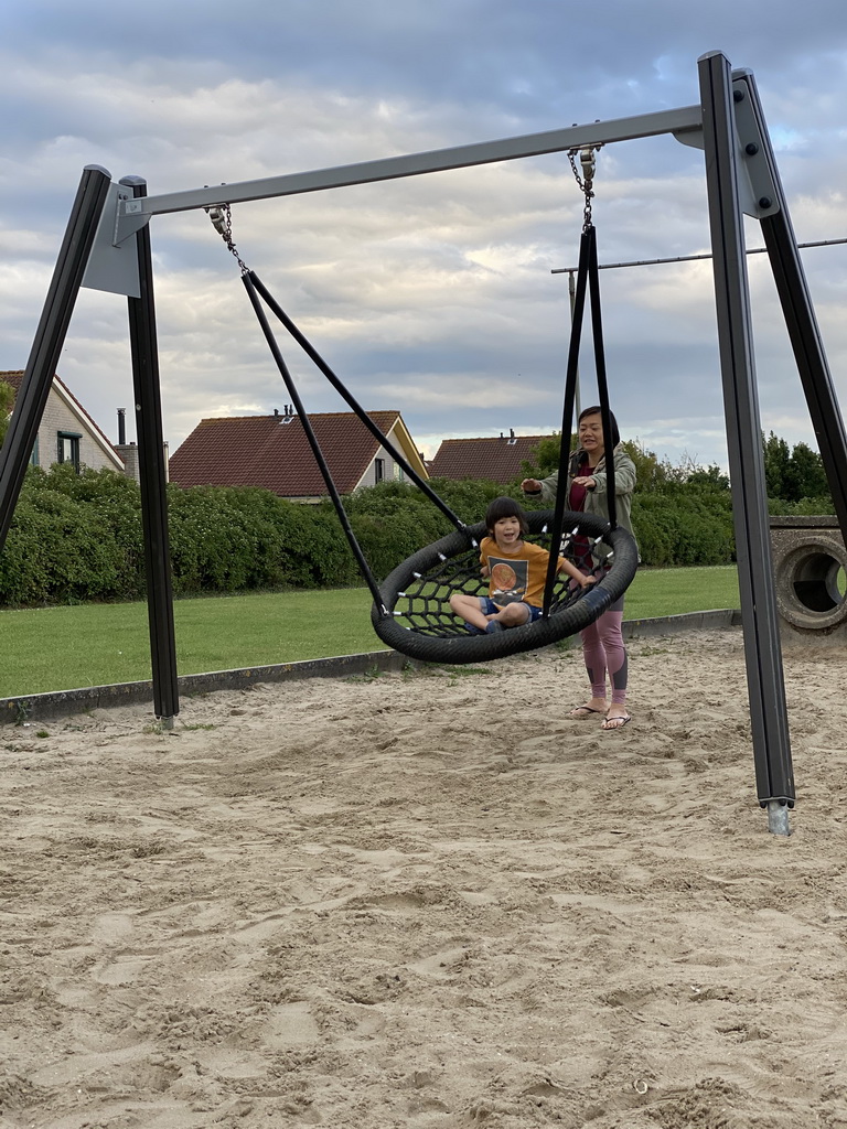 Miaomiao and Max on a swing at the playground at the Oosterschelde Camping Stavenisse