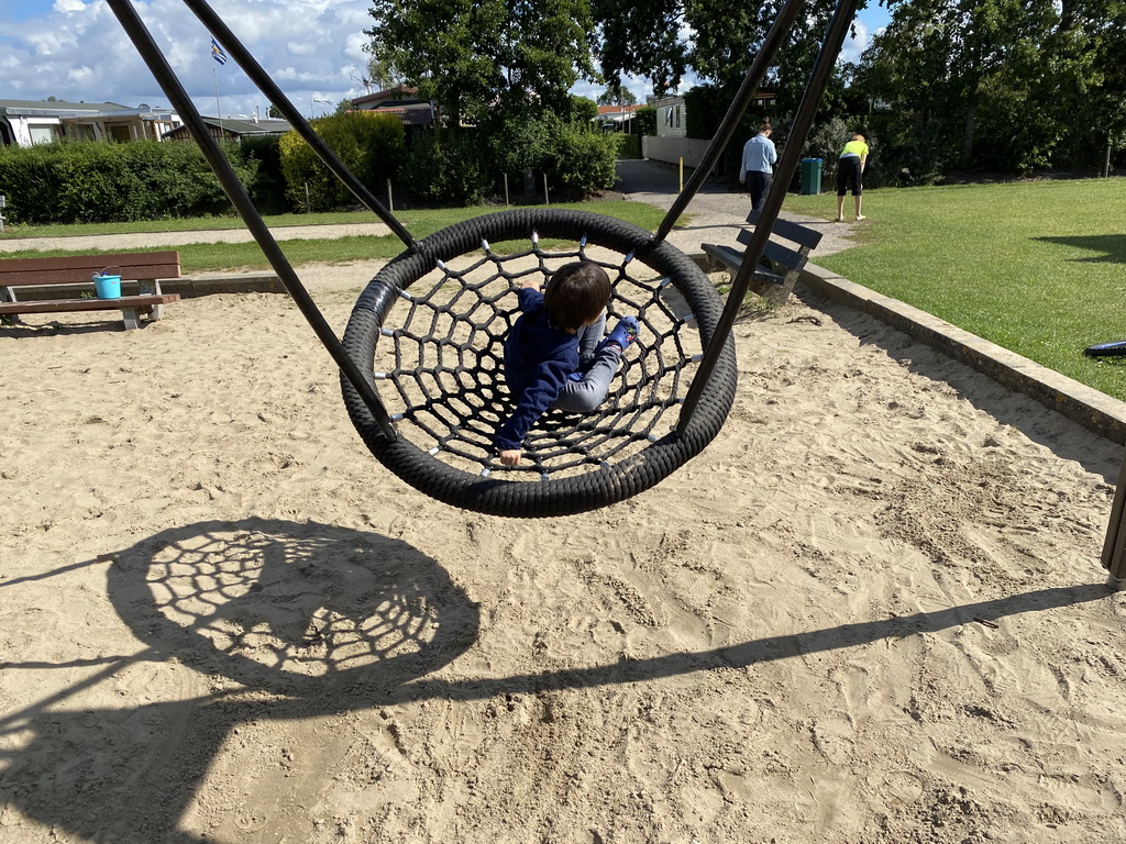 Max on a swing at the playground at the Oosterschelde Camping Stavenisse