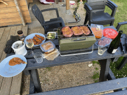Barbecue with meat at the terrace of the Stuurhut holiday home at the Oosterschelde Camping Stavenisse