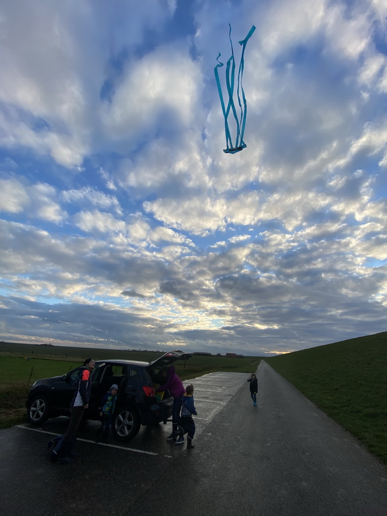 Max flying a kite and our friends at the parking lot at the Dijkweg road