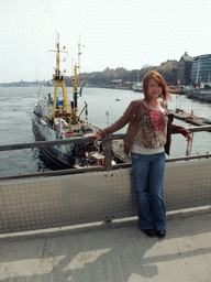 Miaomiao on the Skeppsbron bridge with a view on the Söderström river and the shore of the Södermalm neighborhood