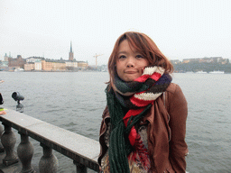Miaomiao in the garden of the Stockholm City Hall, with a view on Riddarfjärden bay, Riddarholmen island and the Södermalm neighborhood