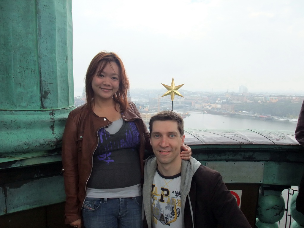 Tim and Miaomiao on top of the main tower of the Stockholm City Hall, with a view on the Gamla Stan and Södermalm neighborhoods