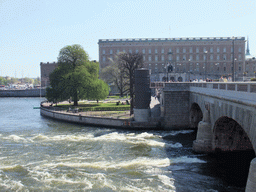 The Norrbro bridge over the Norrström river, the park in front of the Museum of Medieval Stockholm, the Stockholm Palace and the tower of the German Church