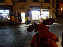 Moose toy in front of the Classic Swedish Souvenir shop at the Västerlånggatan street, by night